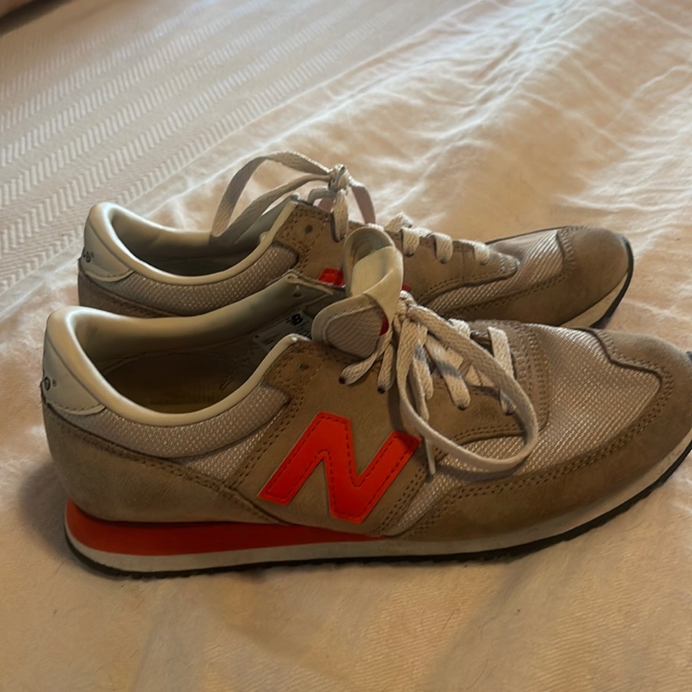 New Balance tan and orange tennis shoe.